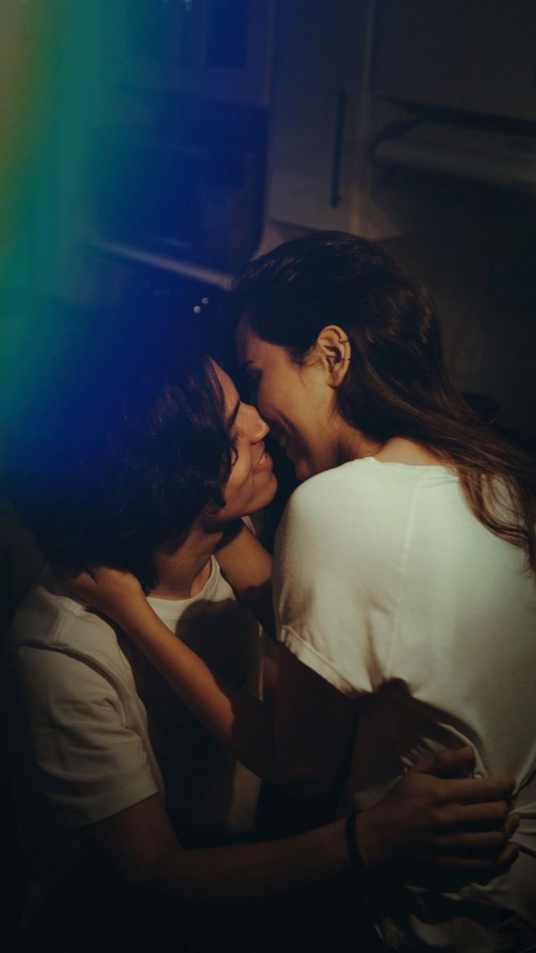 man and woman wearing white top kissing