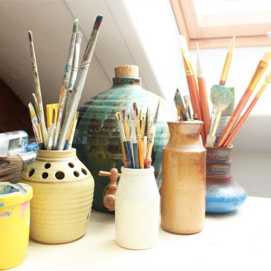 white ceramic jars on white table