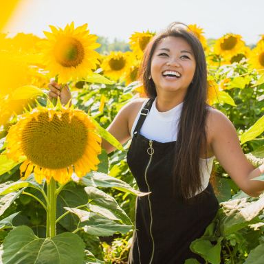 woman surrounded with sunflowers at daytime