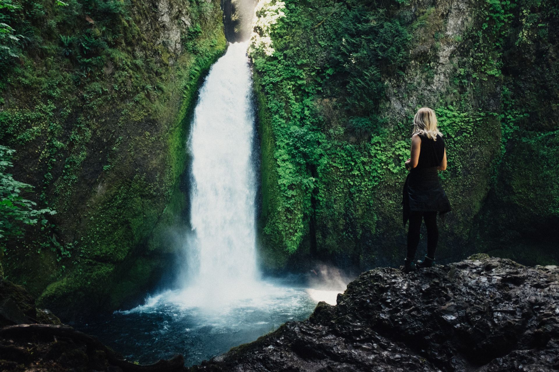 woman in front of waterfalls
