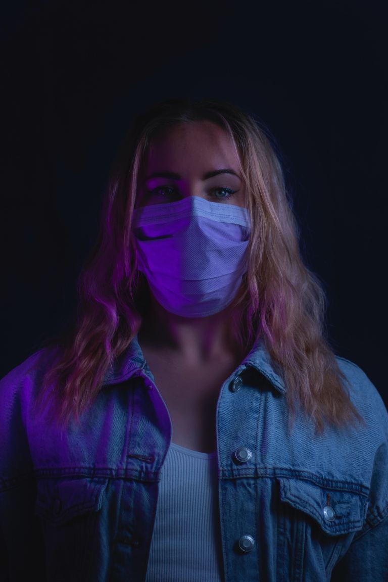 woman in purple denim jacket with white mask