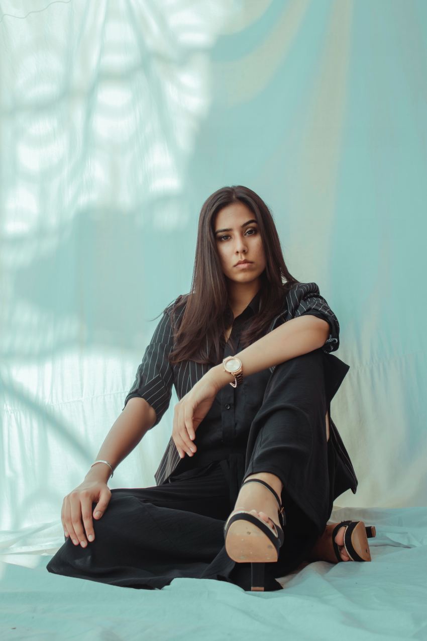 woman in black dress sitting on floor