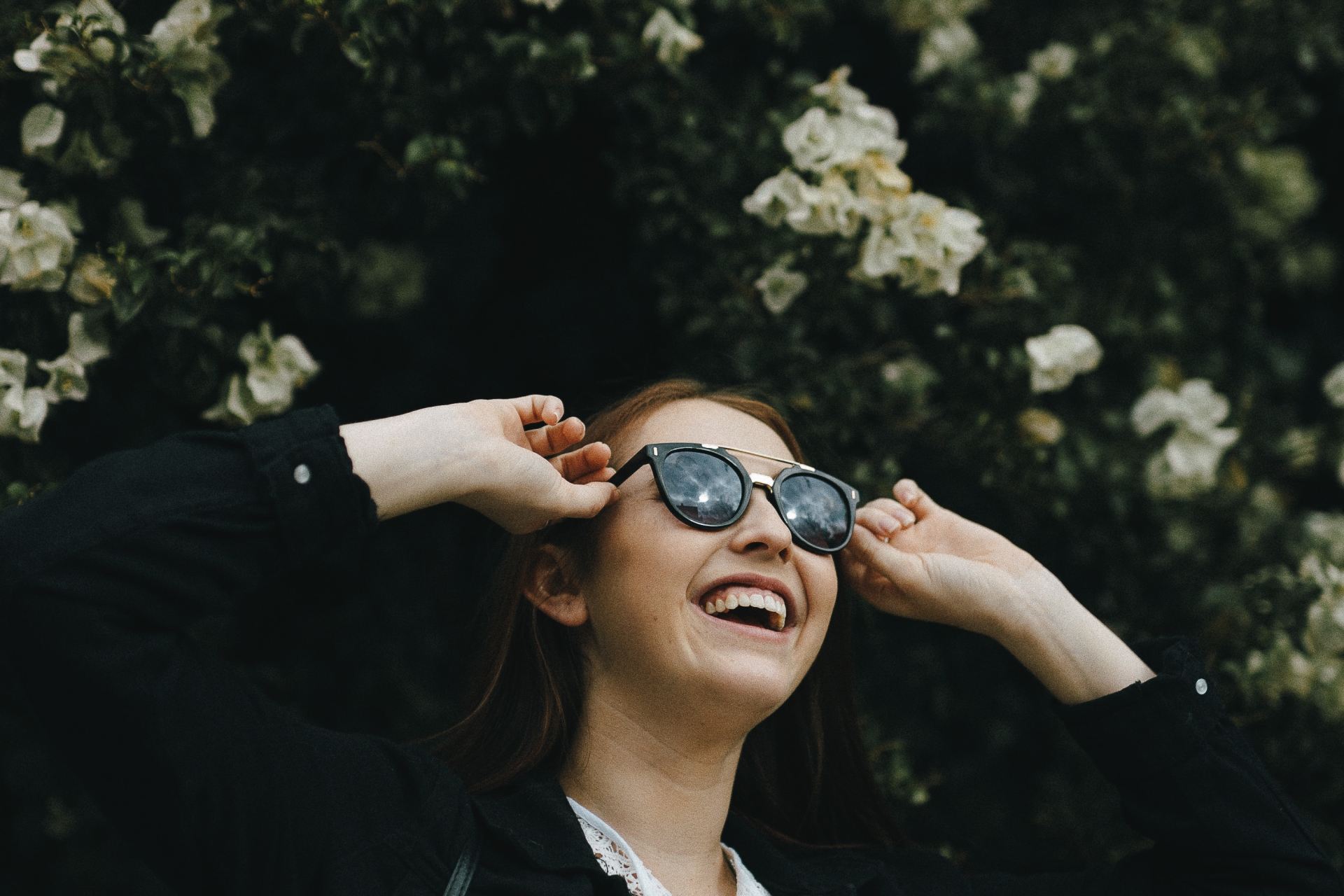 woman in black jacket wearing black sunglasses