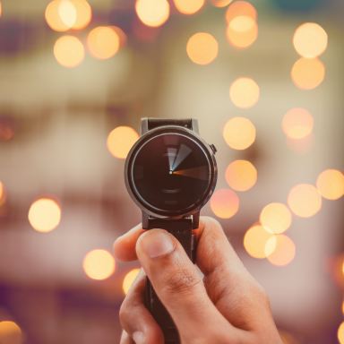 round silver-colored smartwatch bokeh photography