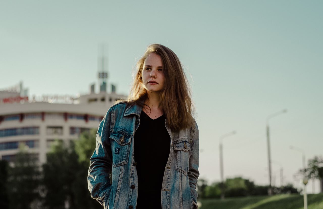 selective focus photography of woman wearing denim jacket