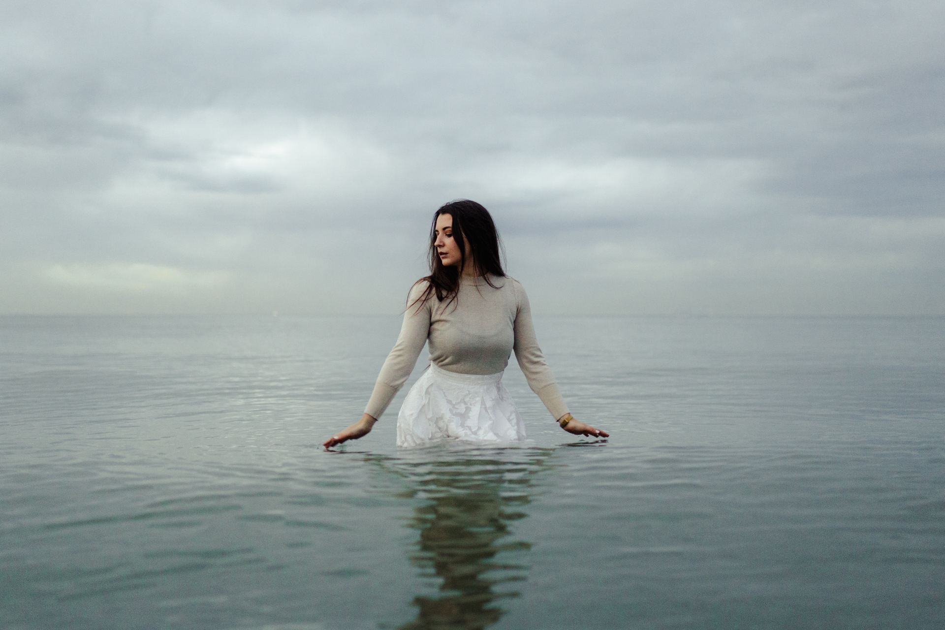 woman in white dress standing on water