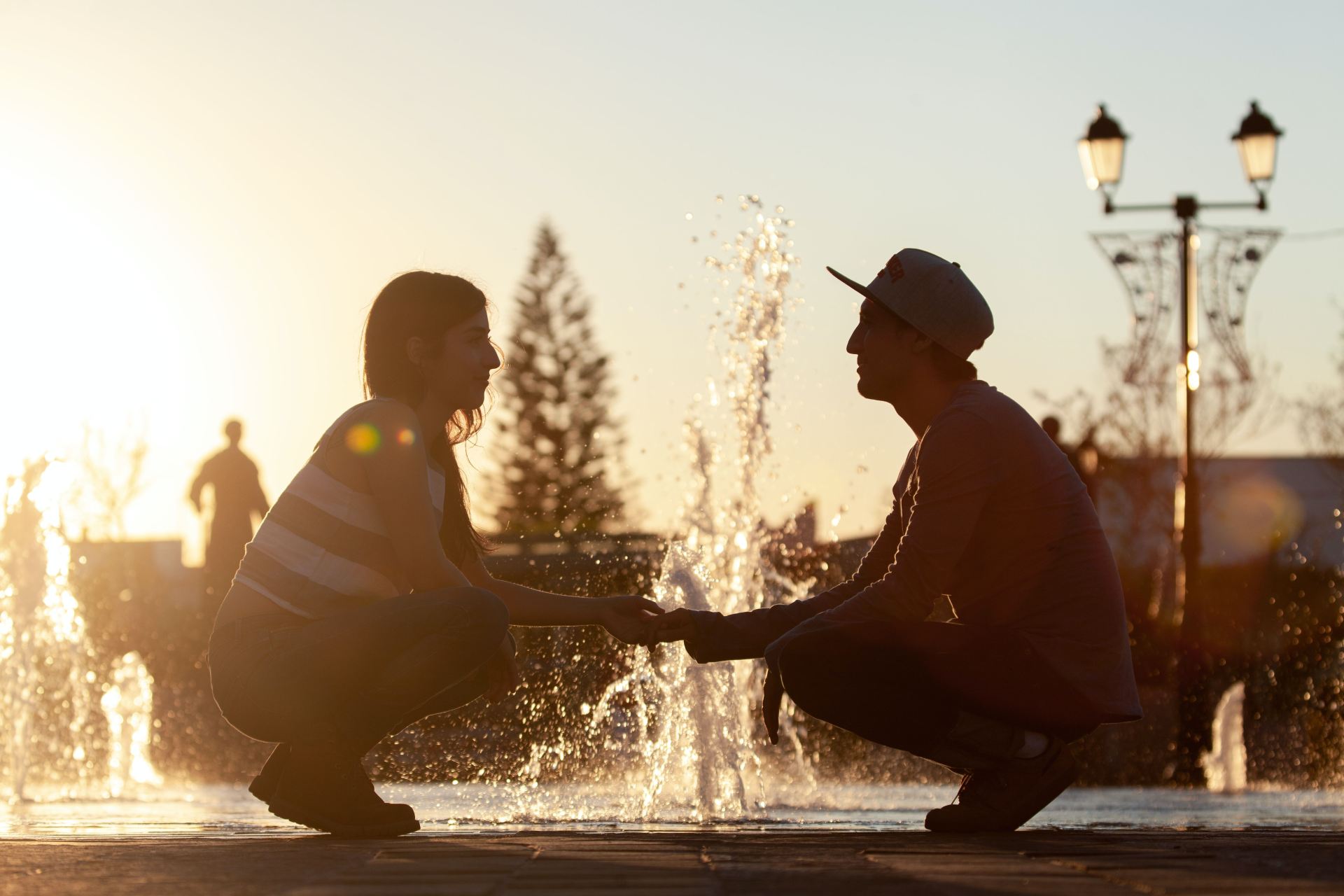 man and woman sitting on water during daytime