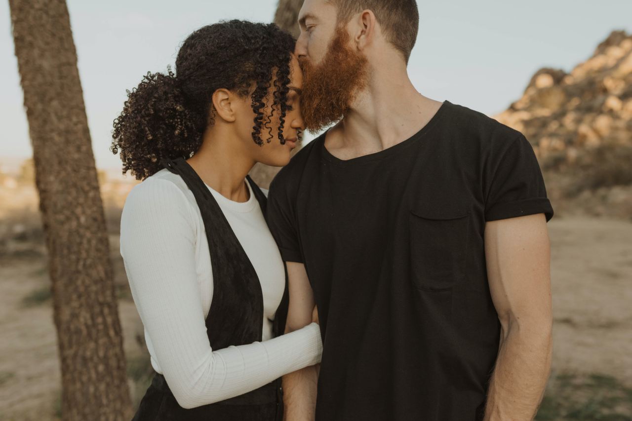 man in black crew neck t-shirt standing beside woman in white long sleeve shirt