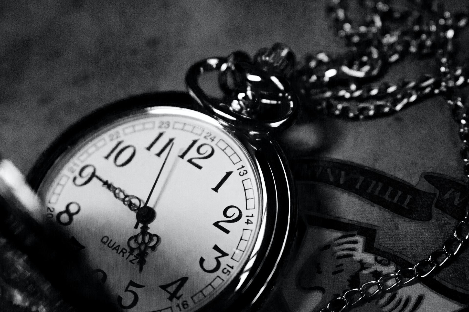 grayscale photography of analog pocket watch