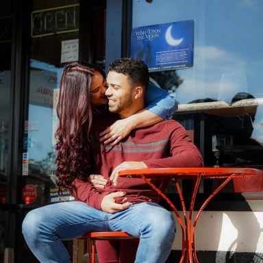 woman kissing man's cheek at daytime