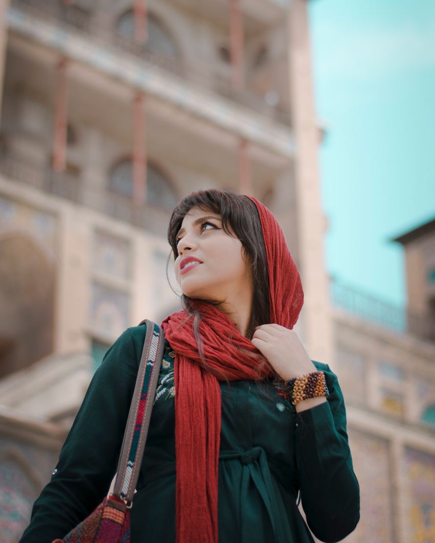 woman in red scarf and black long sleeve shirt